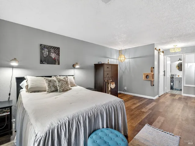 a bedroom with a large bed and a chandelier