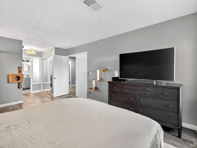 a bedroom with a bed and a flat screen tv