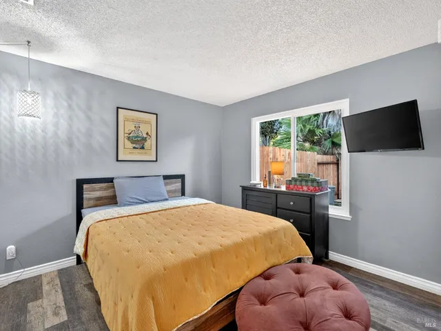 a bed room with a bed and a television