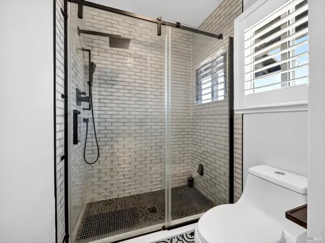 a bathroom with a shower and toilet