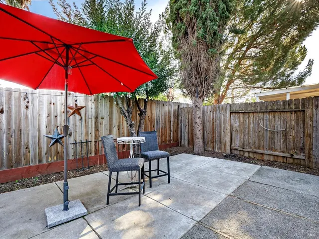 a view of a dining table and chairs in the patio