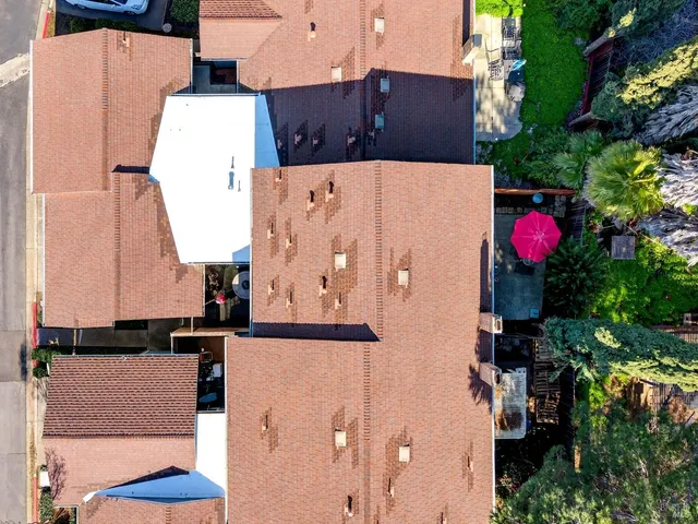 an aerial view of multiple houses with a yard