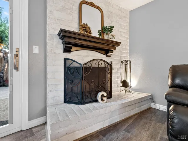 a view of living room with furniture and mirror
