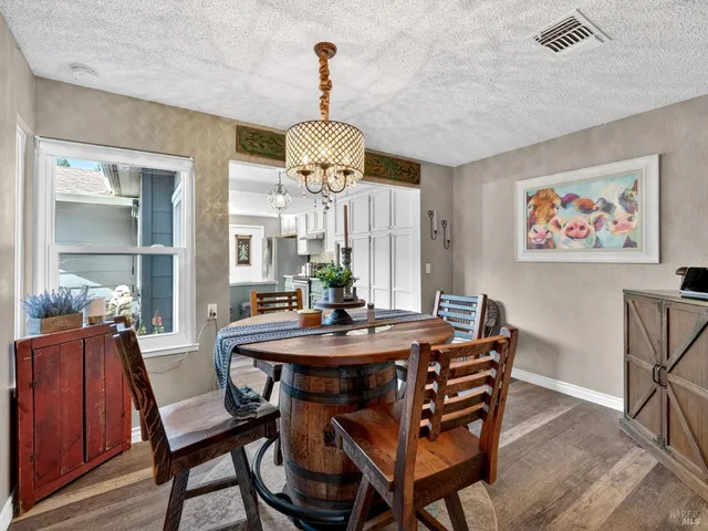 a view of a dining room with furniture wooden floor and chandelier