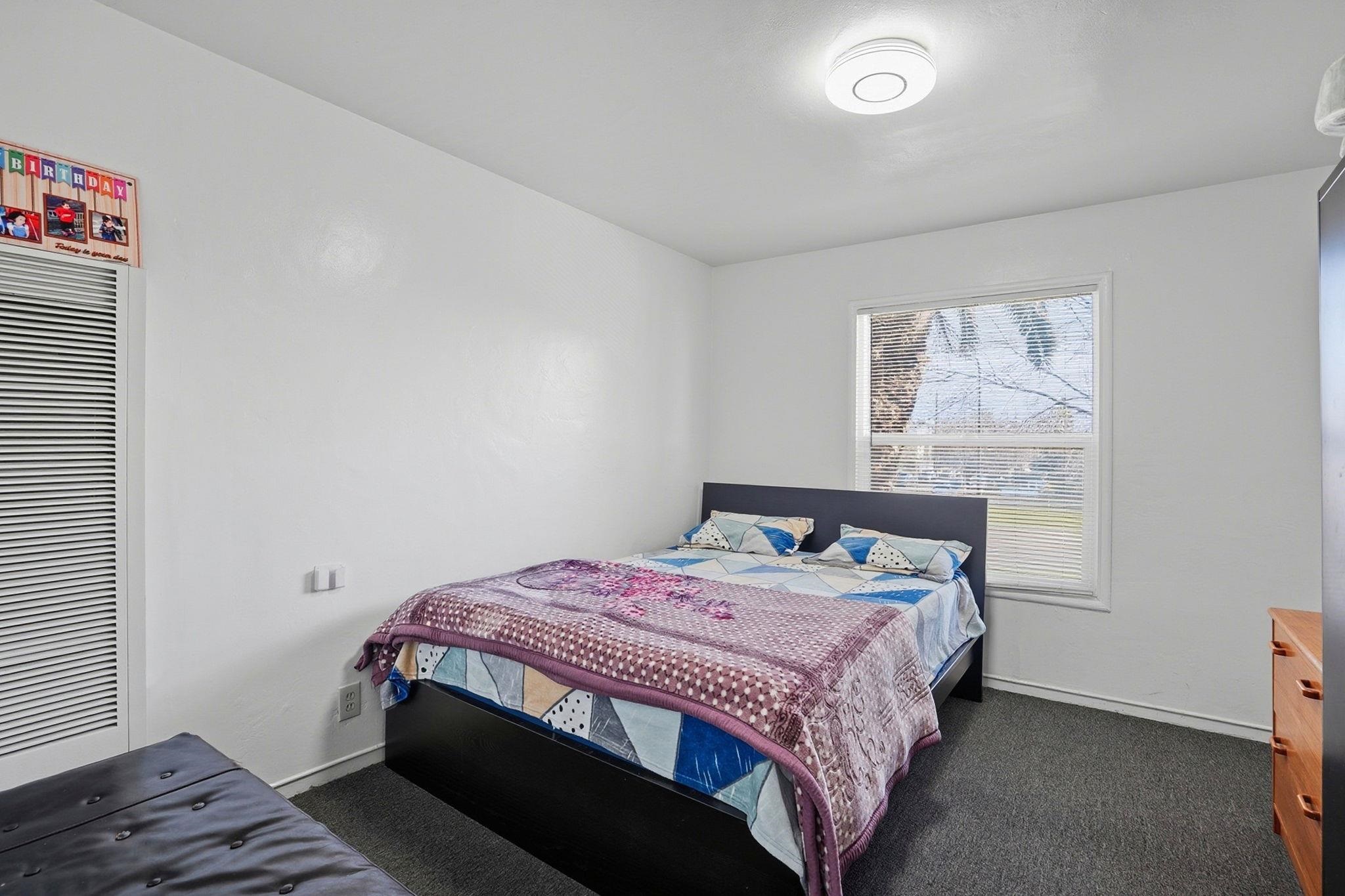 3224 Sacramento Street Berkeley, CA 94702 - Photo 15 of 21 a bedroom with a bed and wooden floor