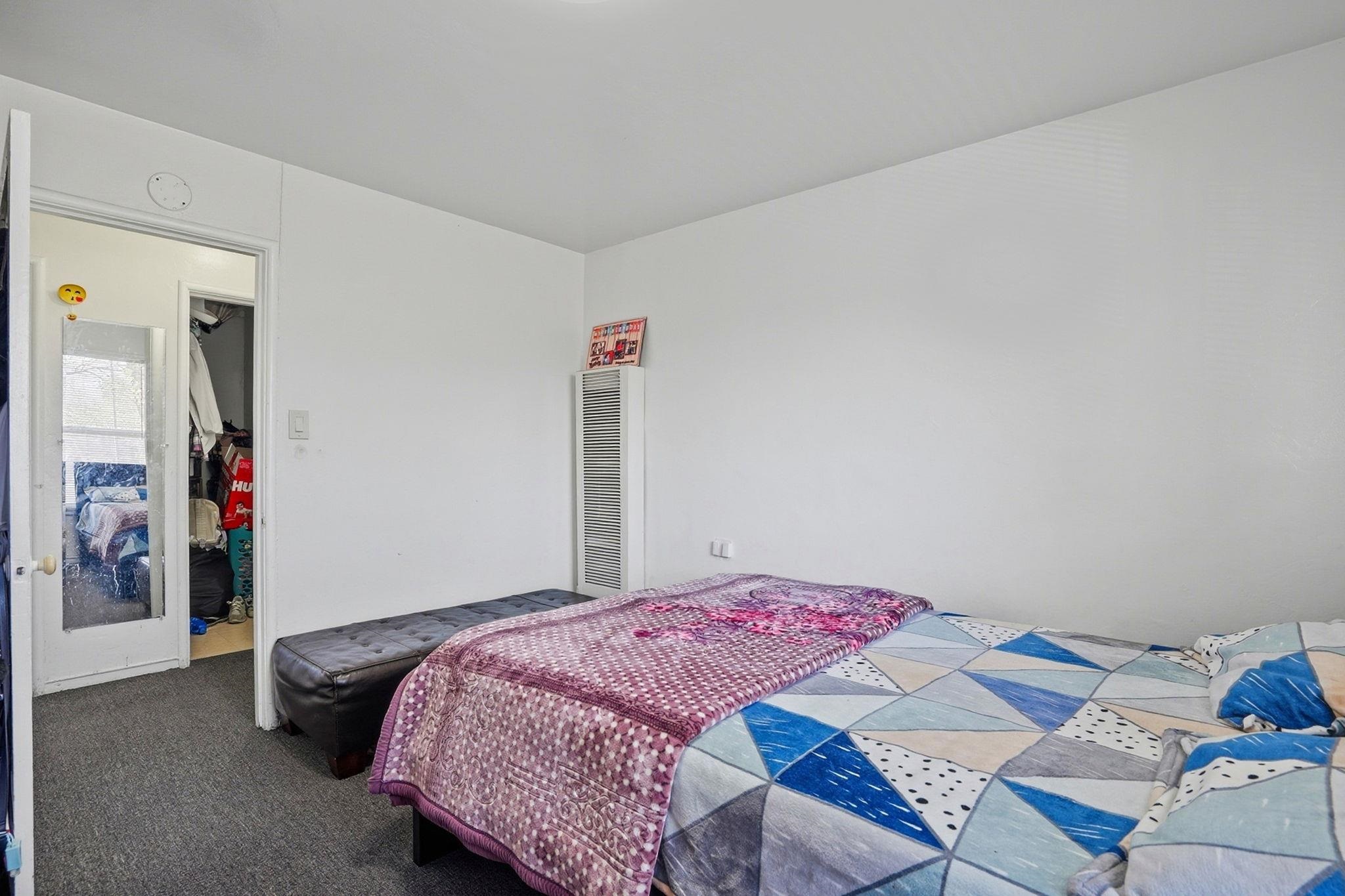 3224 Sacramento Street Berkeley, CA 94702 - Photo 16 of 21 a bedroom with a bed and a chandelier