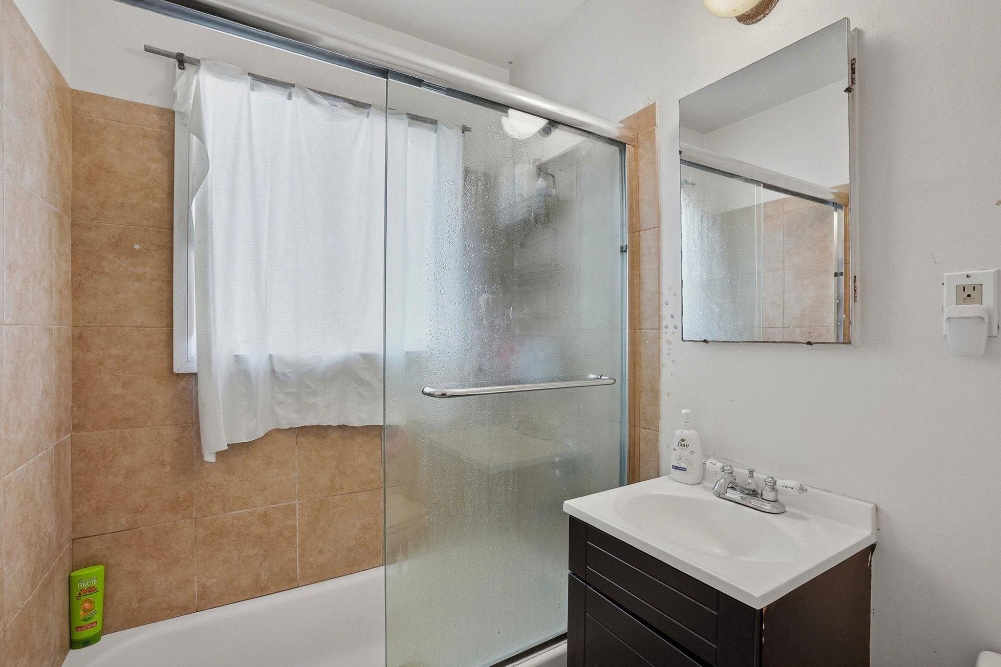 3224 Sacramento Street Berkeley, CA 94702 - Photo 18 of 21 a bathroom with a sink mirror and a shower