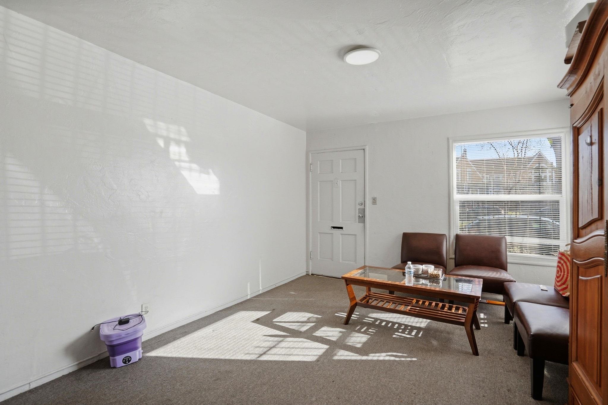 3224 Sacramento Street Berkeley, CA 94702 - Photo 5 of 21 a living room with furniture and a window