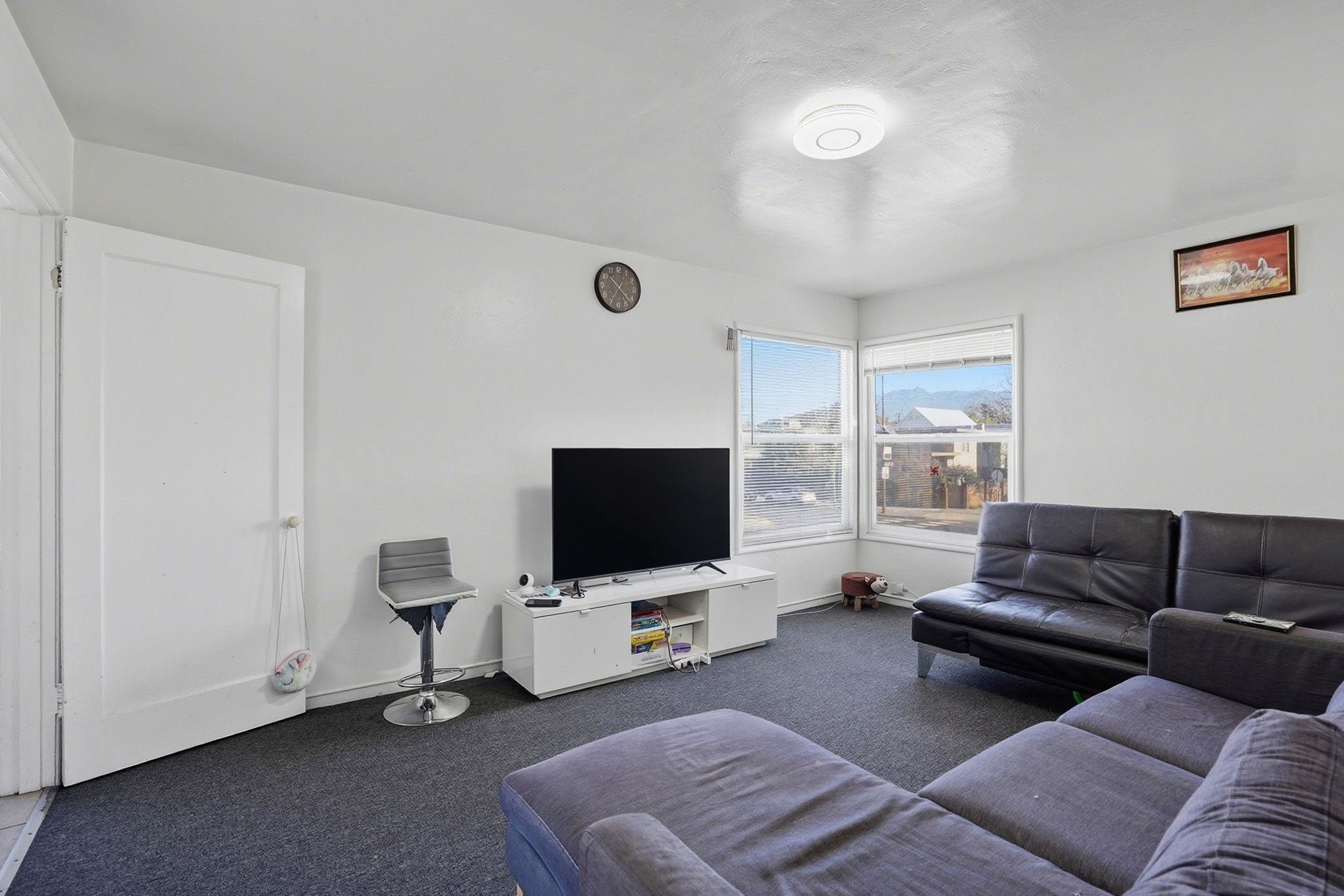 3224 Sacramento Street Berkeley, CA 94702 - Photo 7 of 21 a living room with furniture and a flat screen tv