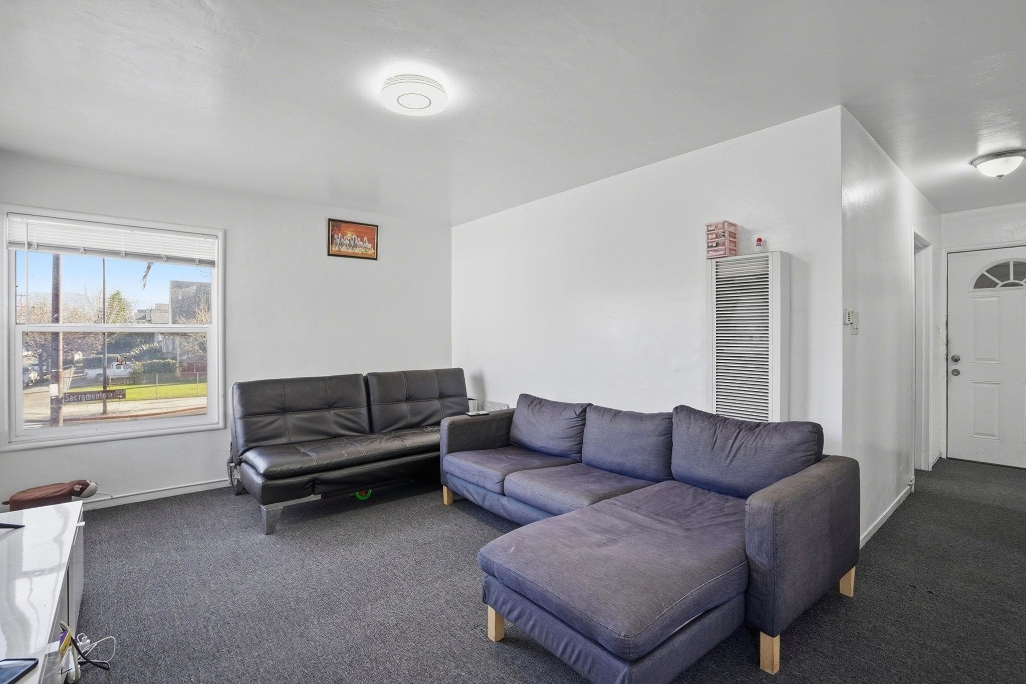 3224 Sacramento Street Berkeley, CA 94702 - Photo 9 of 21 a living room with furniture and a large window