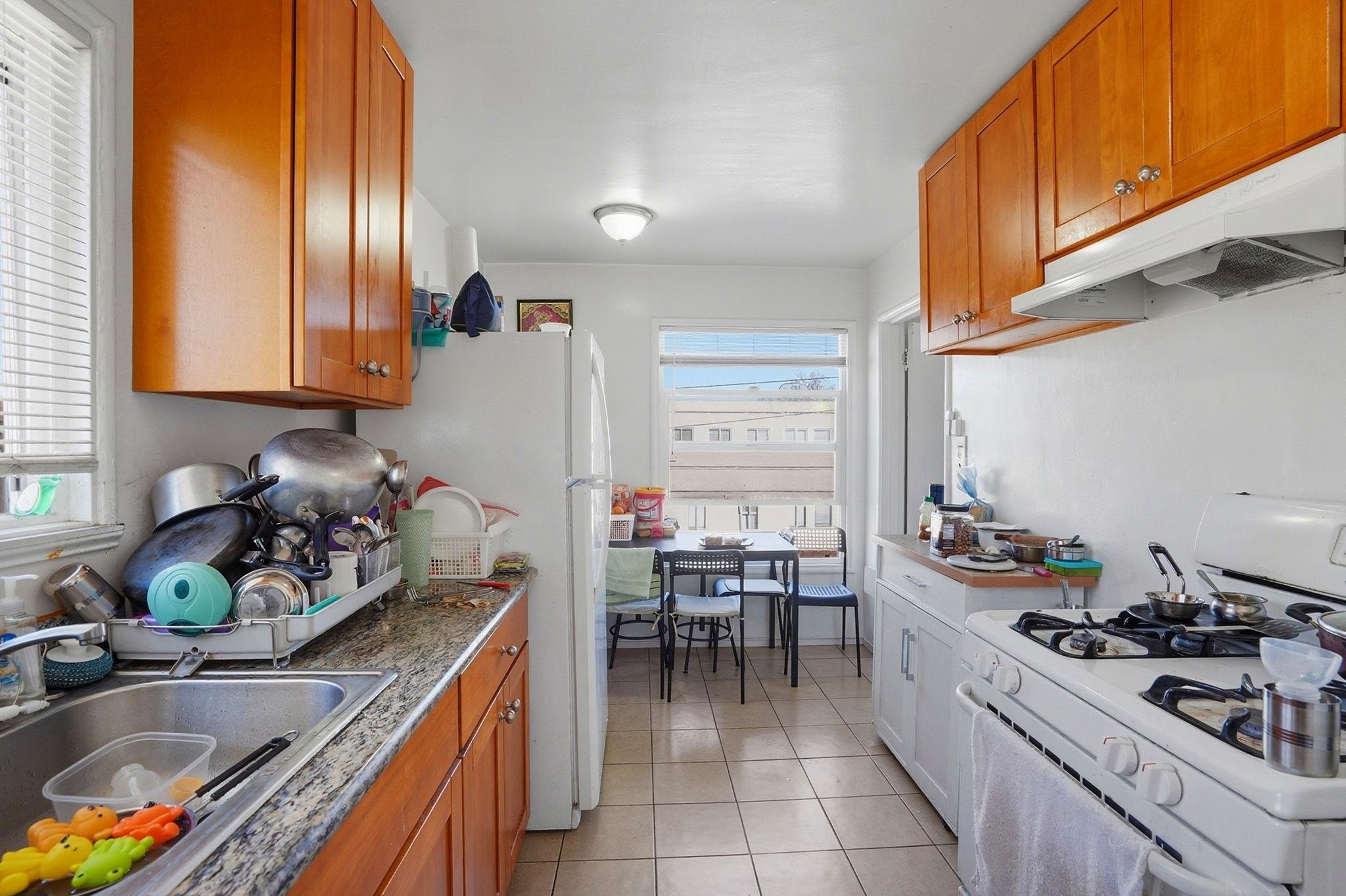 3224 Sacramento Street Berkeley, CA 94702 - Photo 10 of 21 a kitchen with stainless steel appliances granite countertop a sink stove and cabinets