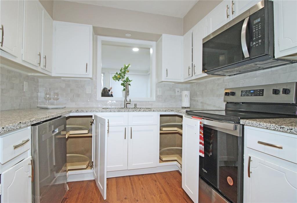 38 La Rue Place Northwest Atlanta, GA 30327 - Photo 12 of 78 a kitchen with granite countertop a sink stainless steel appliances and cabinets