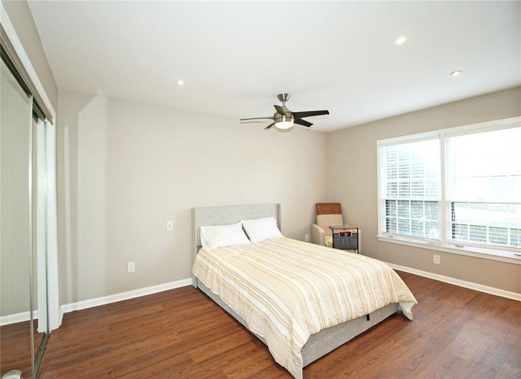 38 La Rue Place Northwest Atlanta, GA 30327 - Photo 19 of 78 a bedroom with a large bed and a large window