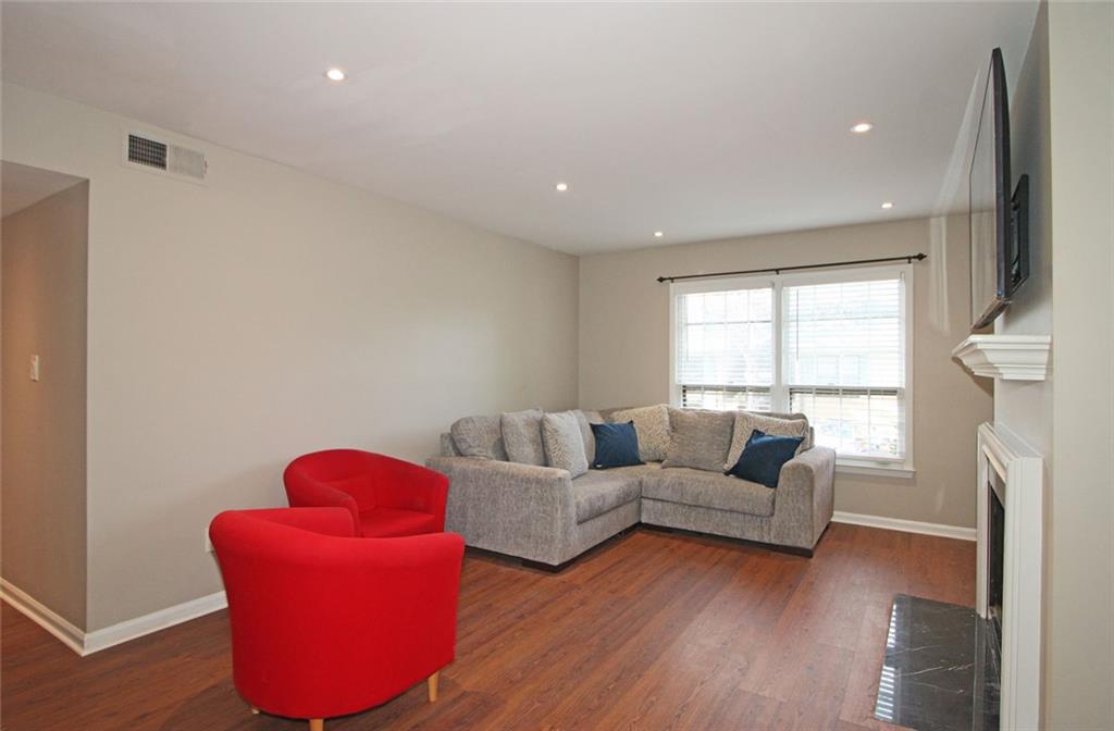 38 La Rue Place Northwest Atlanta, GA 30327 - Photo 2 of 78 a living room with furniture and a fireplace