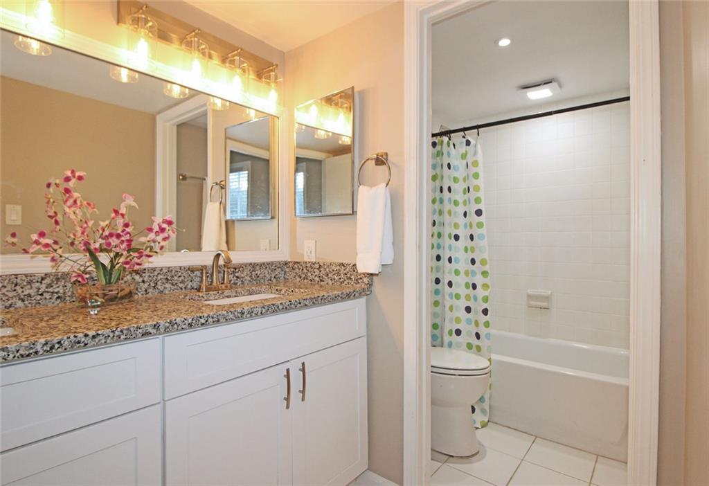 38 La Rue Place Northwest Atlanta, GA 30327 - Photo 22 of 78 a bathroom with a granite countertop sink a toilet and shower