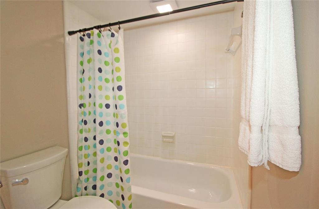 38 La Rue Place Northwest Atlanta, GA 30327 - Photo 23 of 78 a bathroom with a shower curtain and a curtain