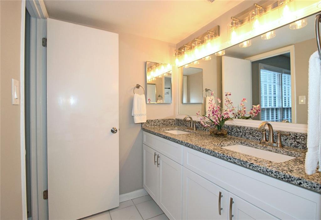 38 La Rue Place Northwest Atlanta, GA 30327 - Photo 24 of 78 a bathroom with a granite countertop sink and a mirror