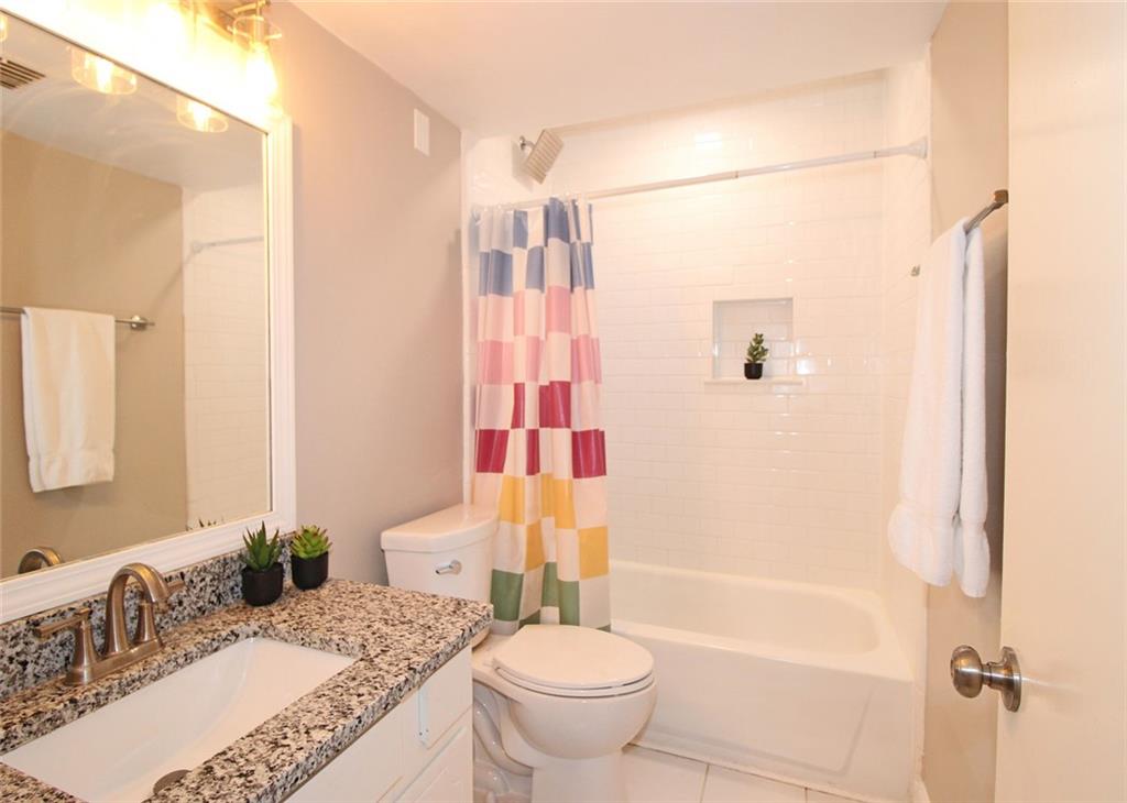 38 La Rue Place Northwest Atlanta, GA 30327 - Photo 27 of 78 a bathroom with a granite countertop sink toilet and shower