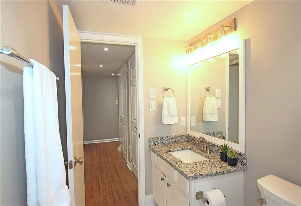 38 La Rue Place Northwest Atlanta, GA 30327 - Photo 29 of 78 a bathroom with a granite countertop sink and a mirror