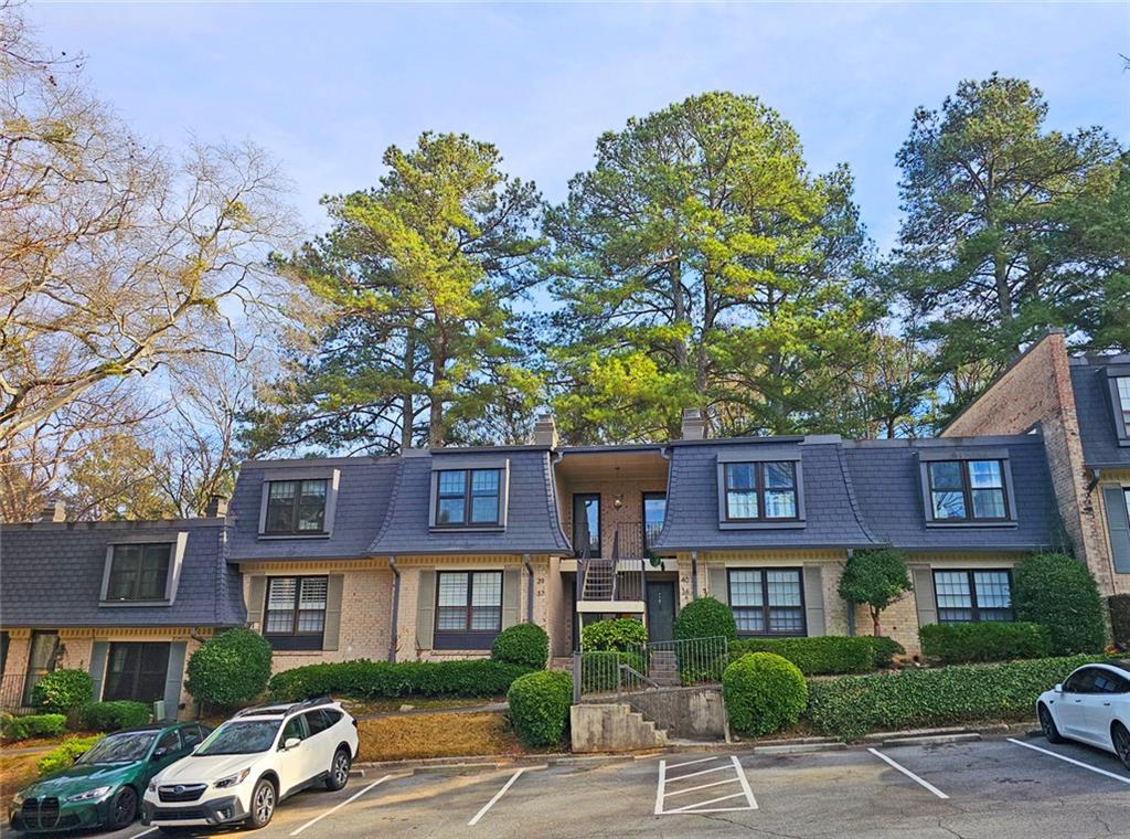 38 La Rue Place Northwest Atlanta, GA 30327 - Photo 34 of 78 a front view of a residential apartment building with a yard