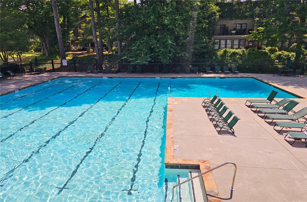 38 La Rue Place Northwest Atlanta, GA 30327 - Photo 53 of 78 a view of swimming pool with seating space and trees in the background