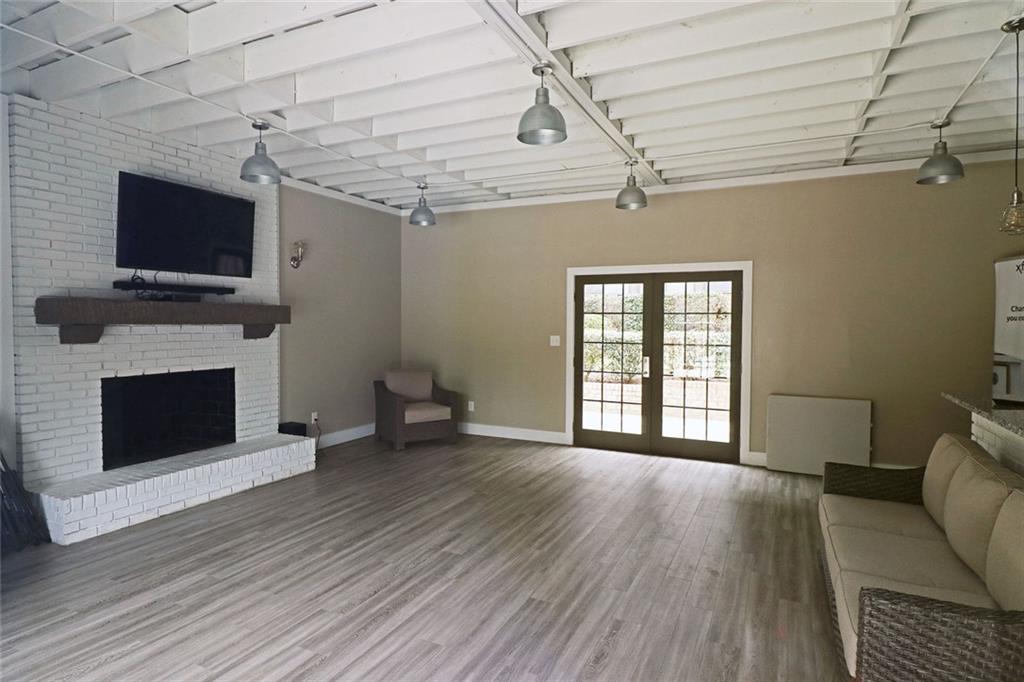 38 La Rue Place Northwest Atlanta, GA 30327 - Photo 72 of 78 a living room with furniture a flat screen tv and a fireplace