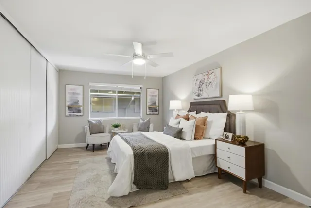 a bed room with a bed and a chair