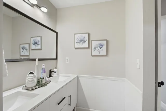 a bathroom with a granite countertop sink a mirror and vanity