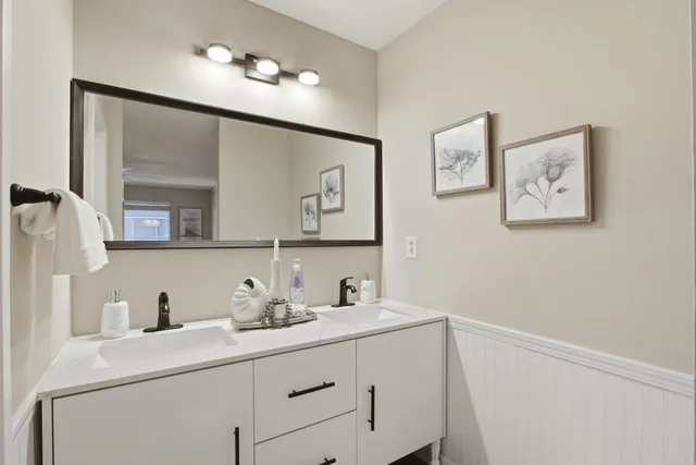 a bathroom with a sink vanity and a mirror