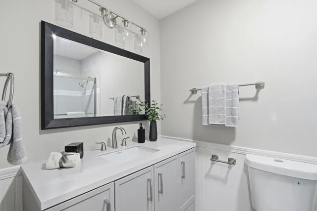 a bathroom with a sink vanity and a mirror
