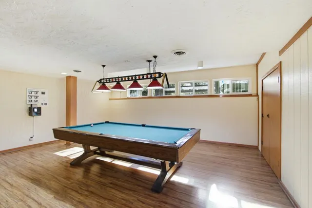 a room with wooden floor and table