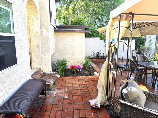 a view of outdoor living space with furniture and a potted plant