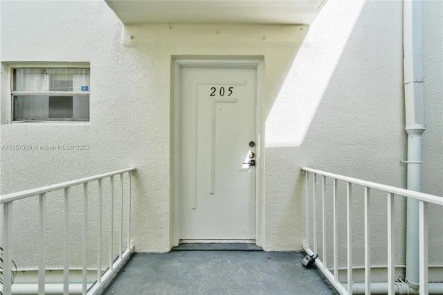 a view of a hallway with wooden floor and entryway