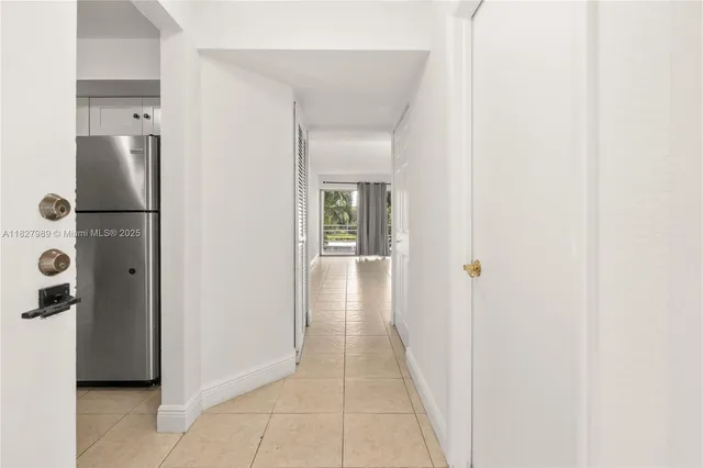 a view of a hallway with a white cabinet and a hallway