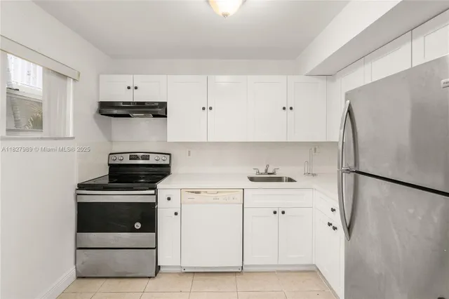 a kitchen with cabinets and white stainless steel appliances