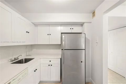 a white refrigerator freezer sitting inside of a kitchen