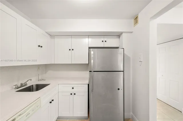 a white refrigerator freezer sitting inside of a kitchen