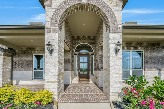 a front view of a house with a garden