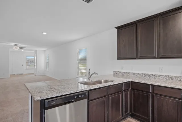a kitchen with a sink and cabinets