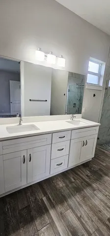 a bathroom with a double vanity sink and mirror
