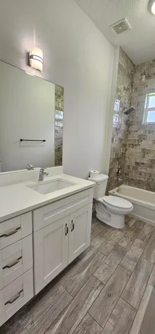 a bathroom with a double vanity sink toilet and a mirror