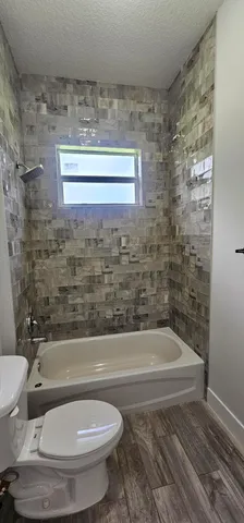 a bathroom with a toilet and a bathtub