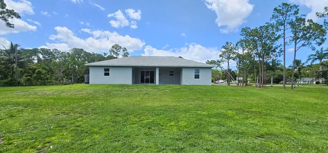 a view of a house with a backyard