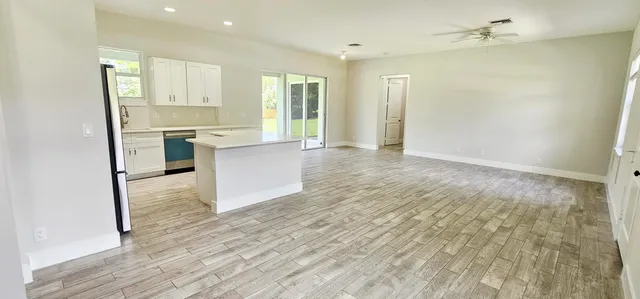 a kitchen with a refrigerator and a stove top oven