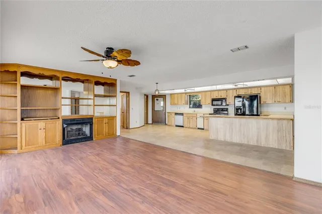 a kitchen with stainless steel appliances granite countertop a stove and a microwave
