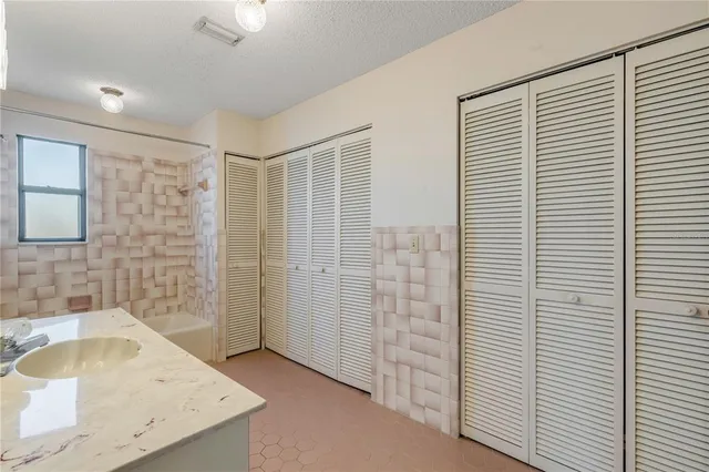 a bathroom with a sink toilet vanity and shower