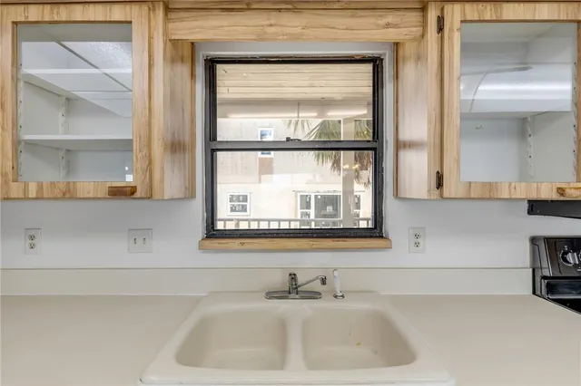 a view of a house with a yard and a large tree front of it