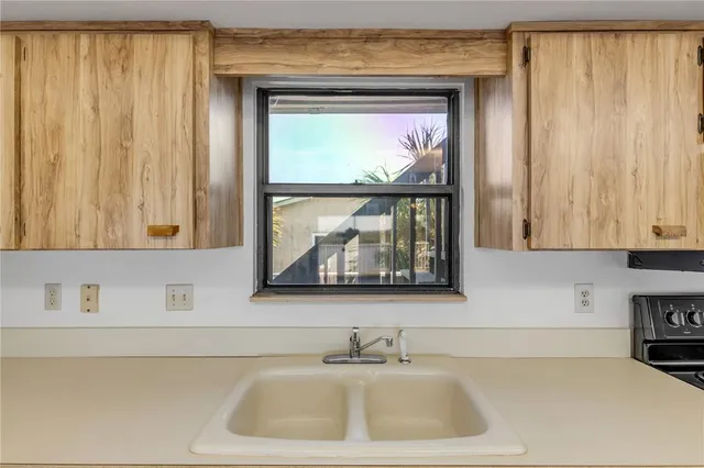 a kitchen with stainless steel appliances kitchen island granite countertop a refrigerator and stove