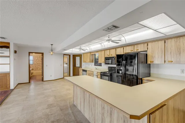 a kitchen with stainless steel appliances granite countertop a sink and cabinets