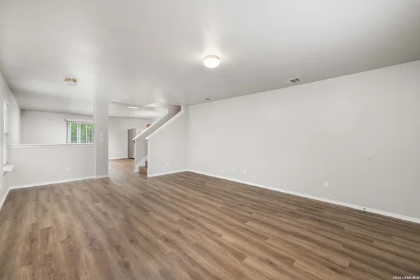 wooden floor in an empty room with a window